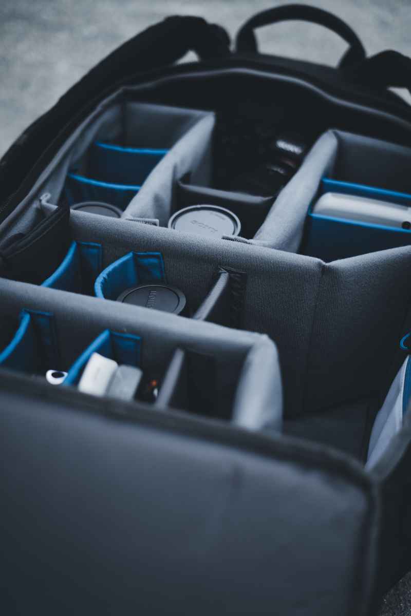 Soft case interior with padded dividers organizing camera lenses and accessories